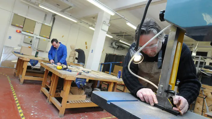 Technicians using equipment in the fine art workshops