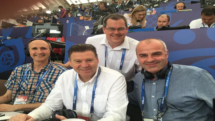 Four commentators at stadium