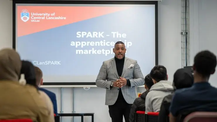 Aaron Willis giving a presentation to a group of employers and young people.