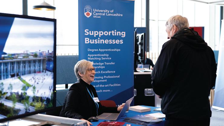 A colleague at the supporting businesses stand.