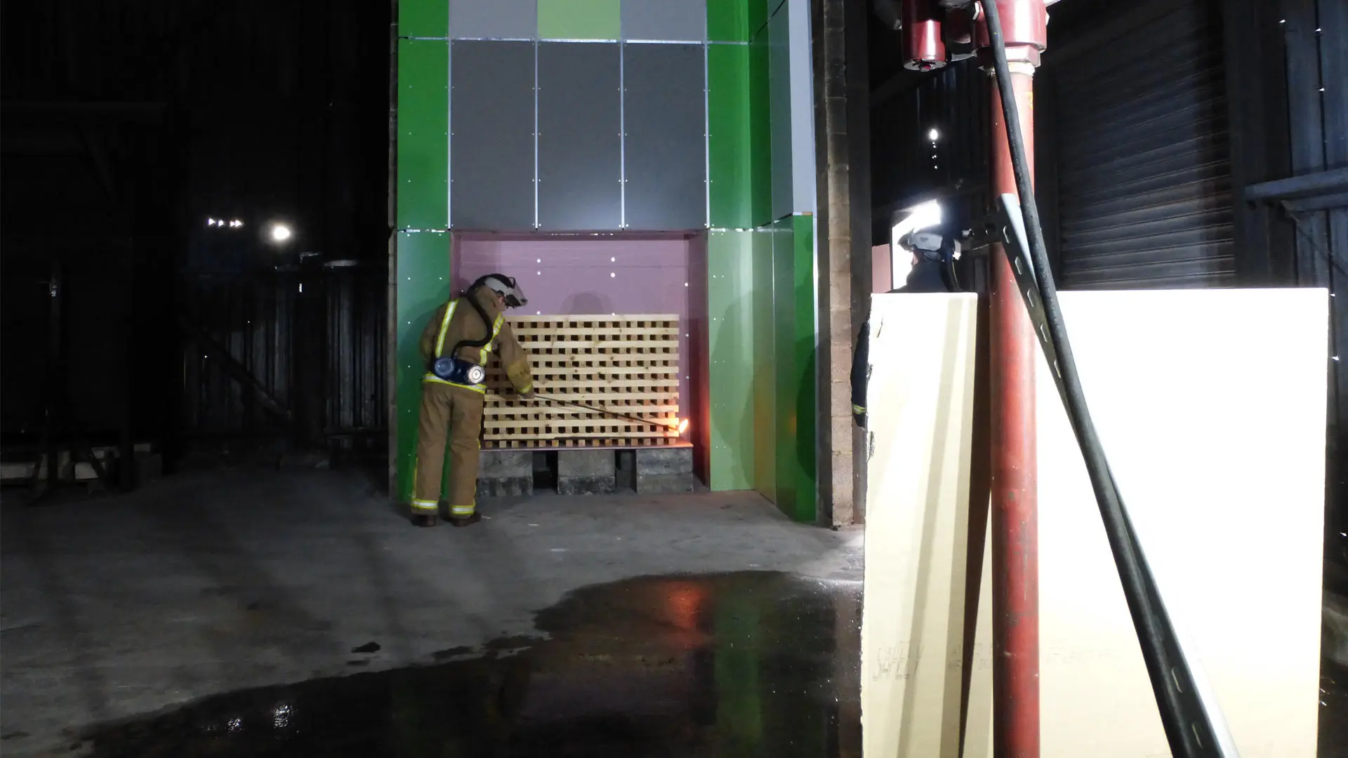 fireman setting fire to some cladding