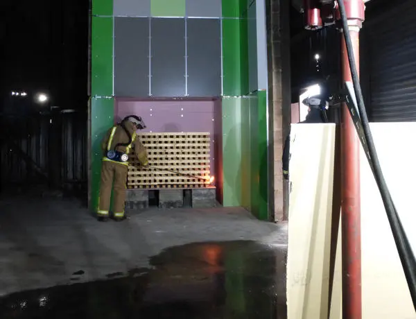 fireman setting fire to some cladding