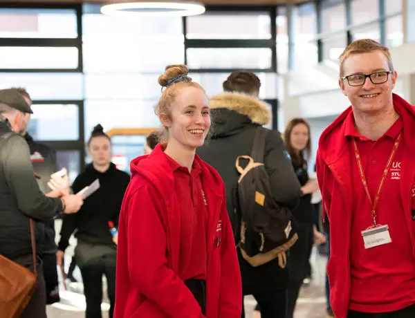 Pair of smiling student helpers at a welcome event