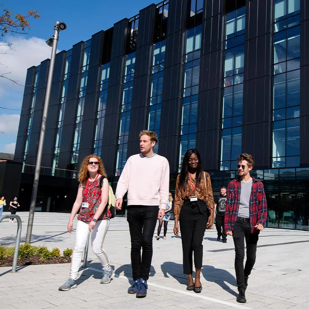 Four students walking outside the Engineering Innovation Centre