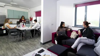 students sat in the lounge and kitchen at Ribble hall