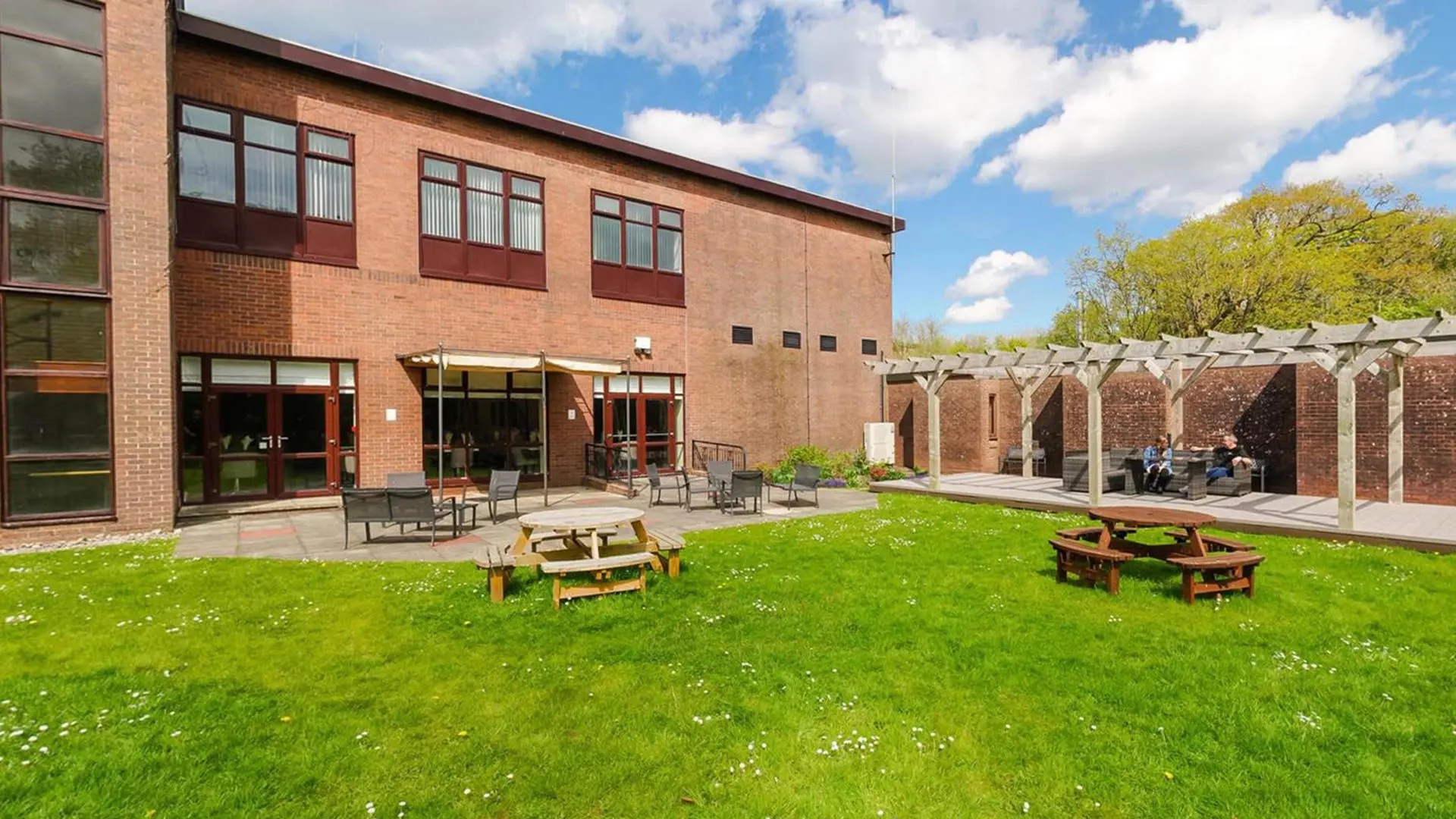 summergrove halls exterior image of the outside terrace with picnic tables