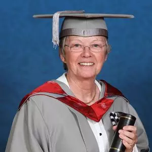 Honorary fellow wearing cap and gown