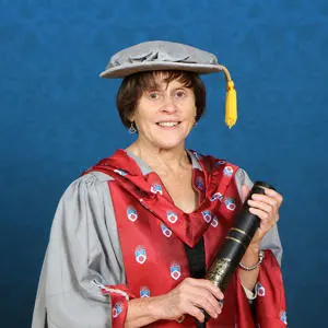 Gillian Hey in graduation gown with Honorary Doctorate