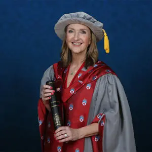 Victoria Derbyshire dressed in graduation gown holding an Honorary Fellow award