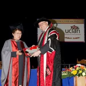 Honorary fellow wearing cap and gown