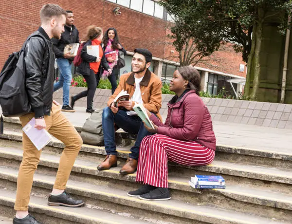 Students sat on steps at university campus