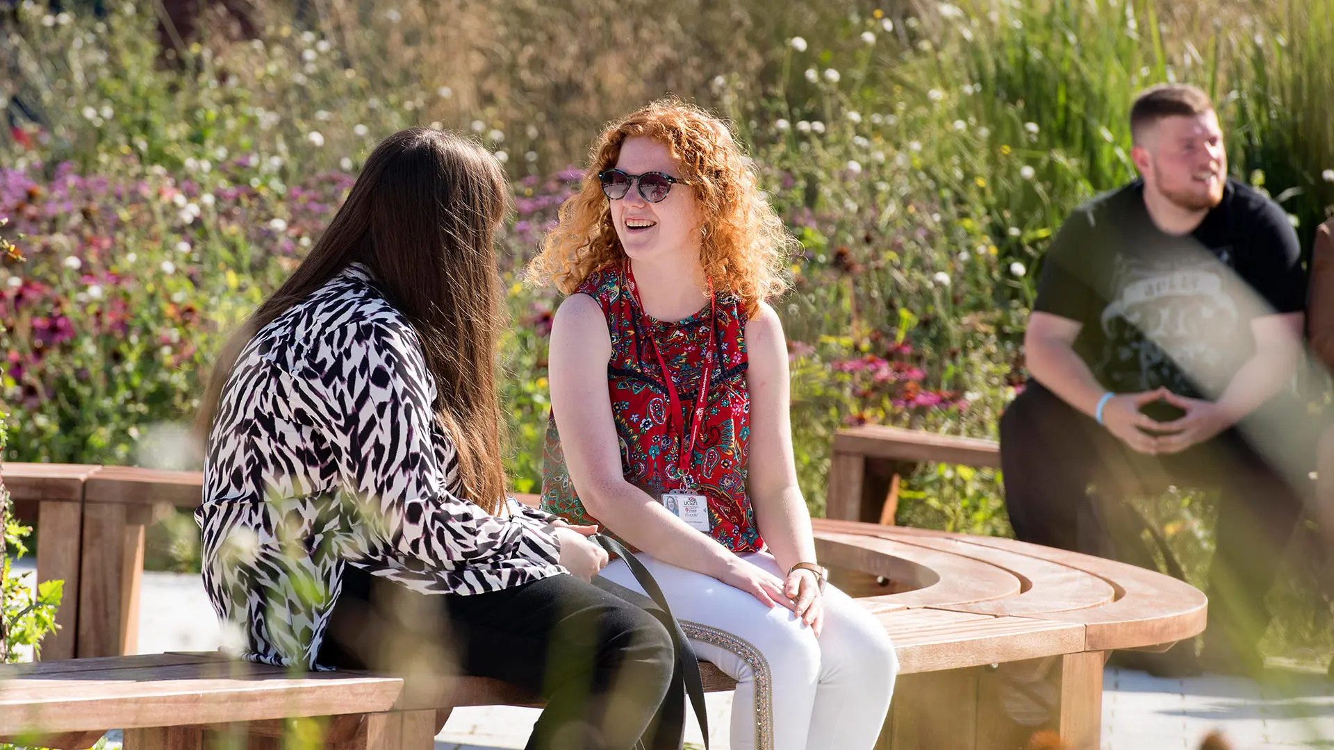 Students chatting on benches on Preston Campus