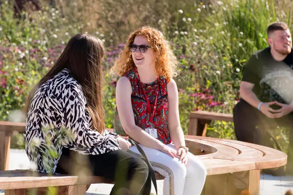 Students chatting on benches on Preston Campus