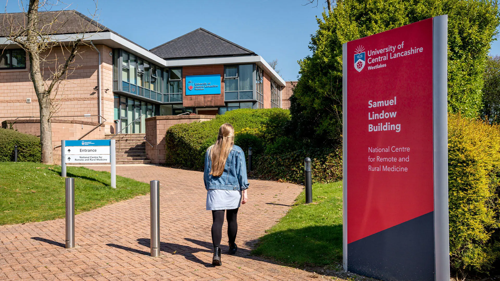 Student walking towards the Samuel Lindow Building at our Westlakes Campus