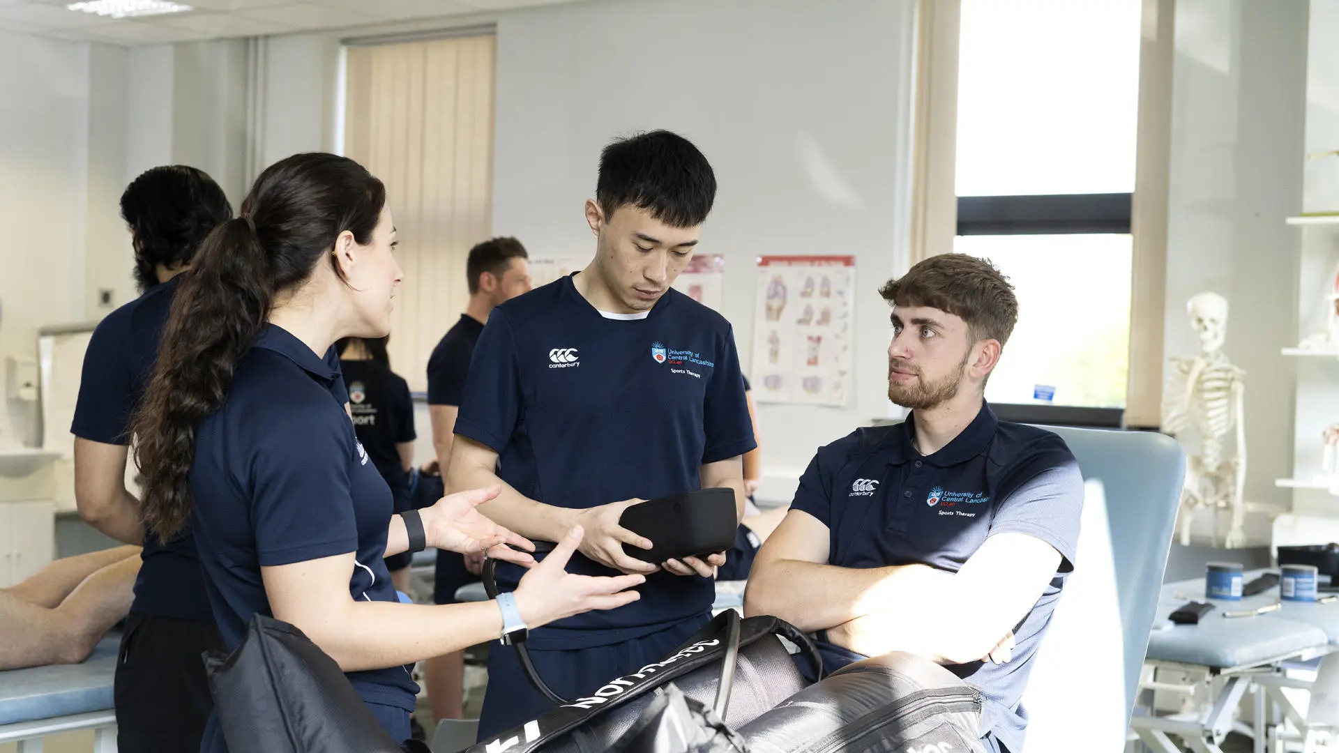 group of students practising sports therapy using equipment