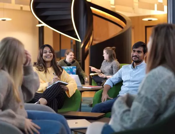 group of students sat chatting in the student centre