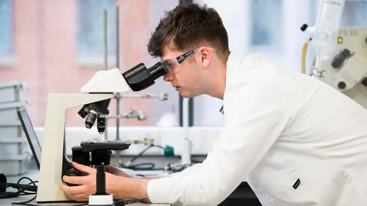Bioveterinary student using microscope