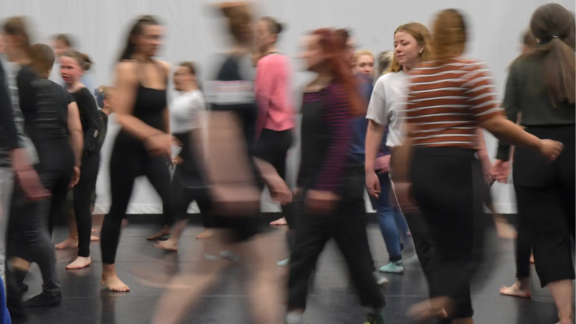 dance studio with multiple people moving around