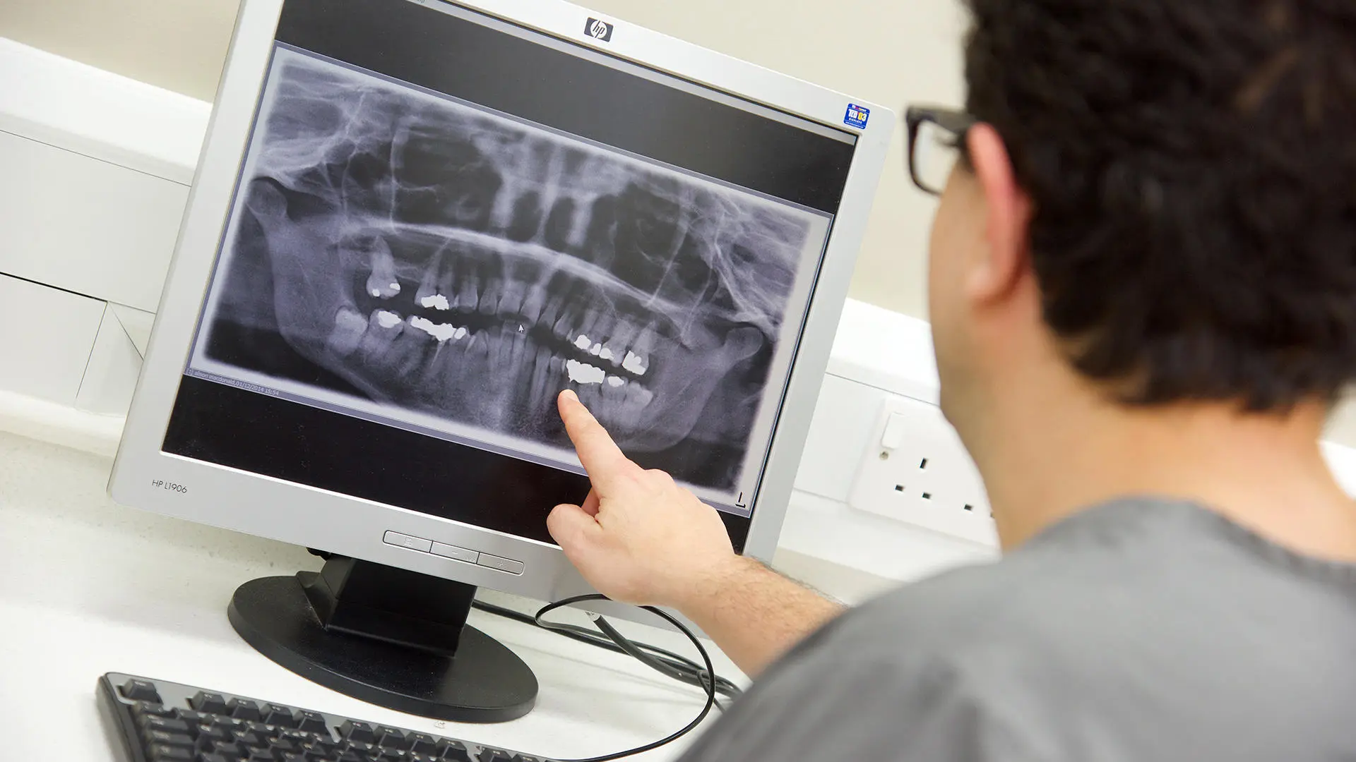 Student from dental implantology working on a computer