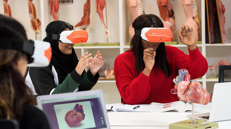Students wearing VR headsets looking at human anatomy
