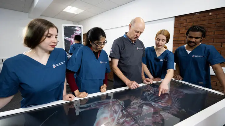 Students and lecturer using Anatomage virtual dissection table