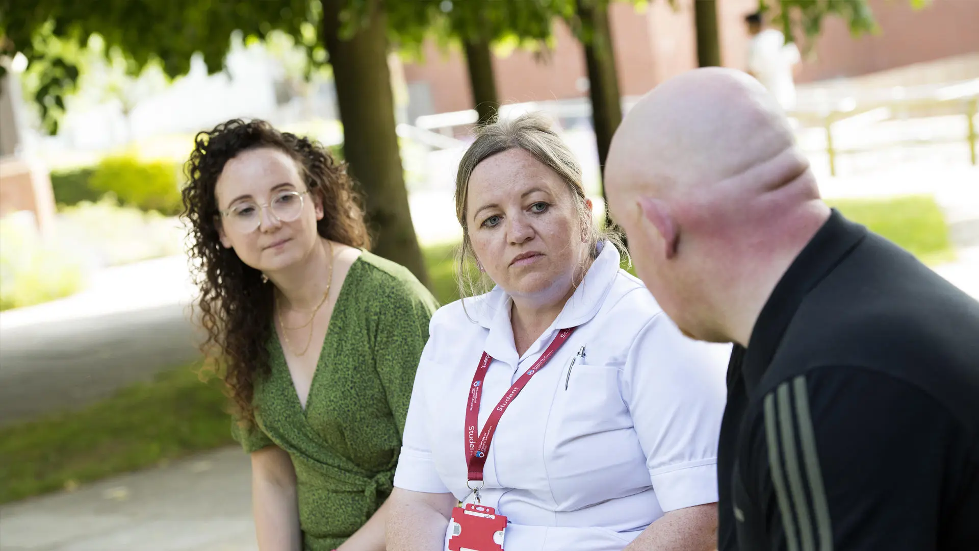 two people chatting with a student nurse
