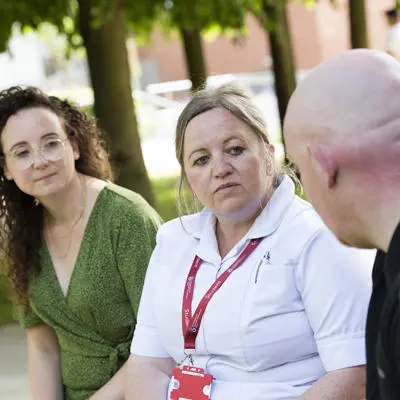 two people chatting with a student nurse