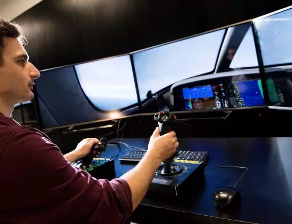 student flying in a flight simulator