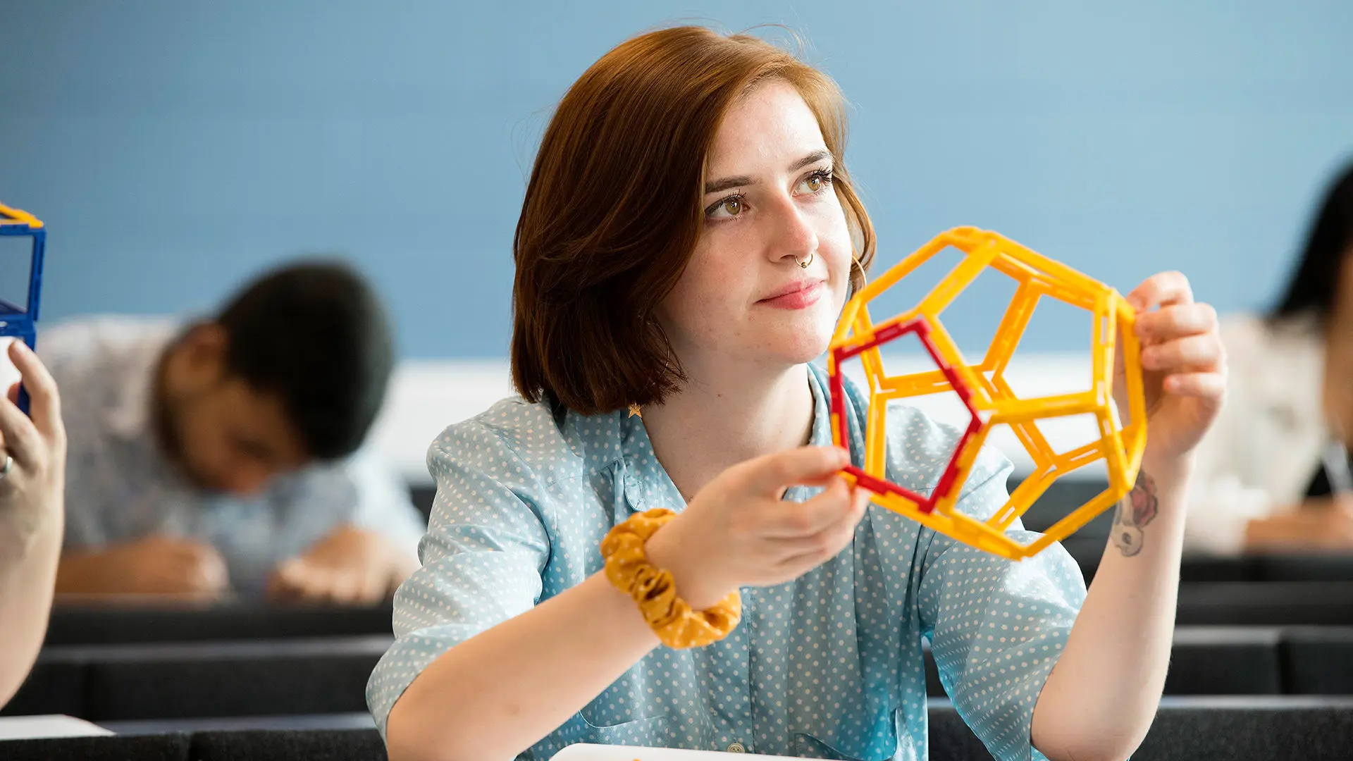student holding a model