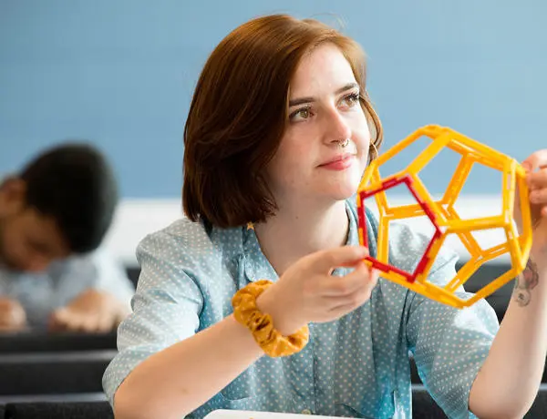 student holding a model