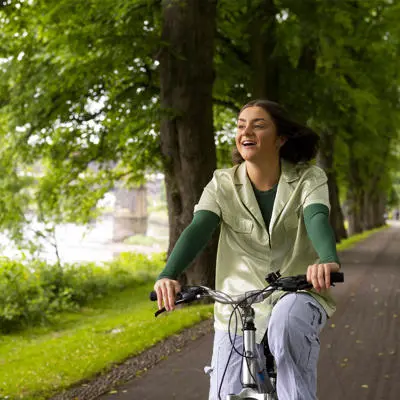 student riding a bike through avenham park