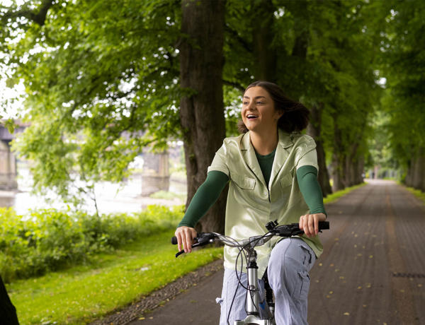 student riding a bike through avenham park
