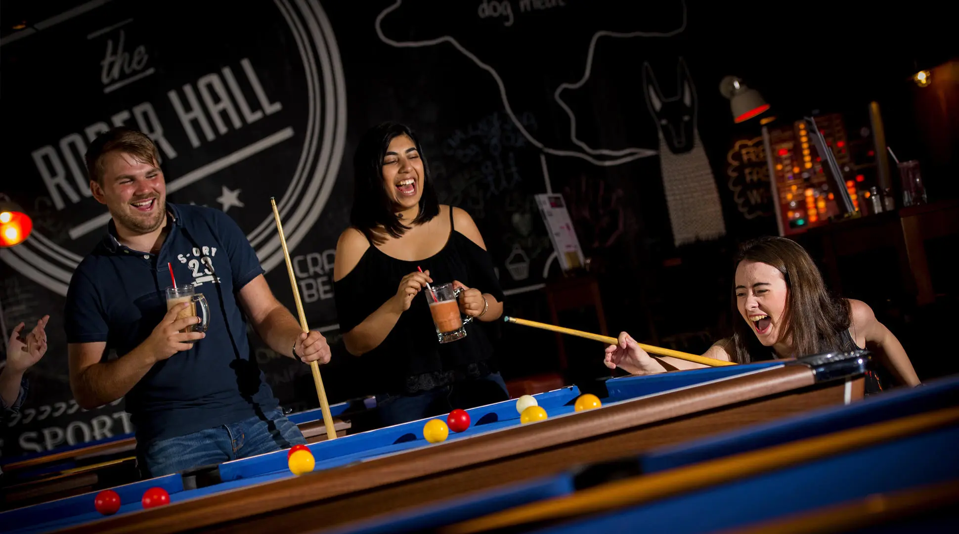 students play pool in roper hall