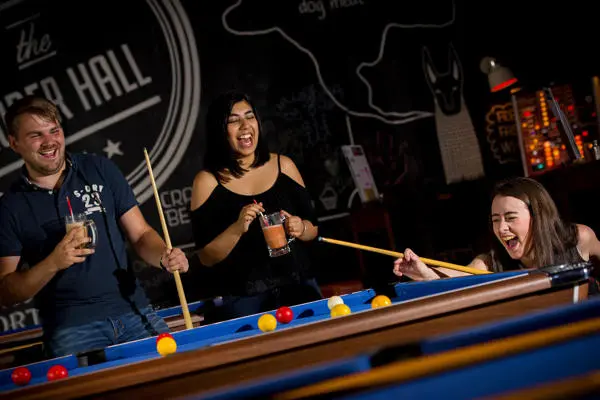 students play pool in roper hall