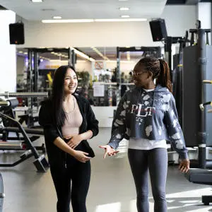 two female students walking through sir tom finney sports centre