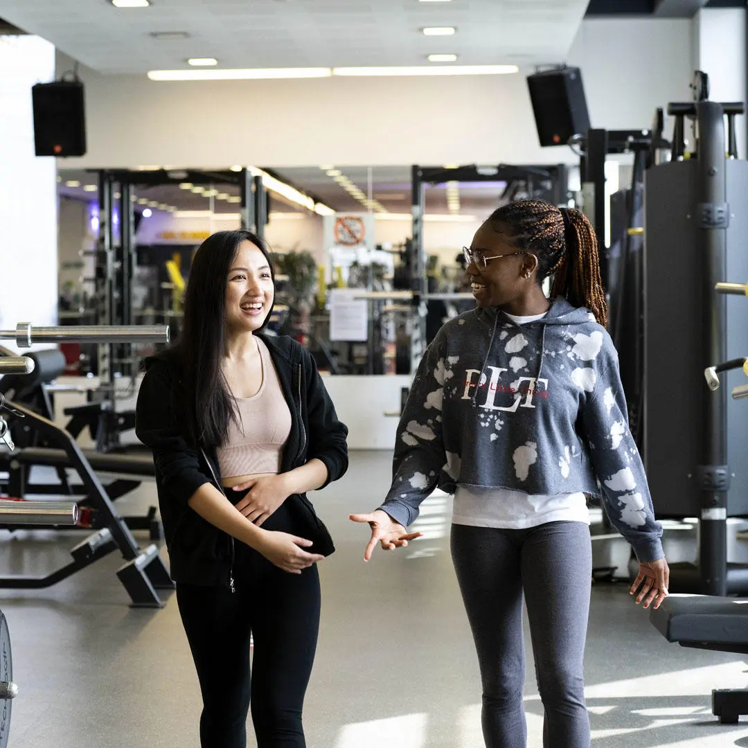 two female students walking through sir tom finney sports centre