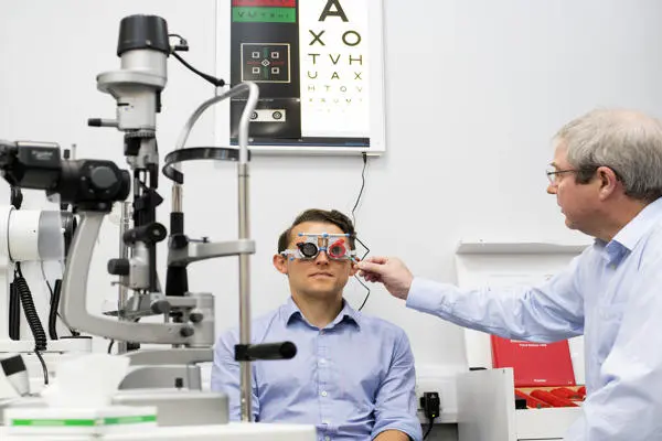 Person having eye examined by optician