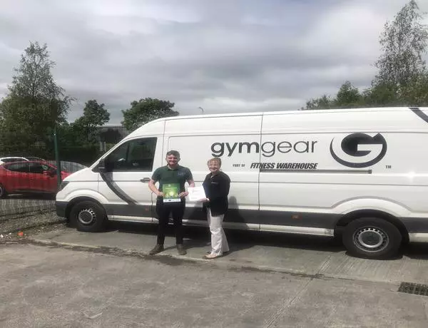 Two men smiling alongside Gymgear van