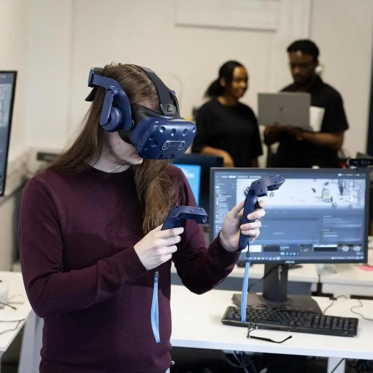 A student using cutting-edge immersive technology.