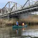 Students canoeing under a bridge