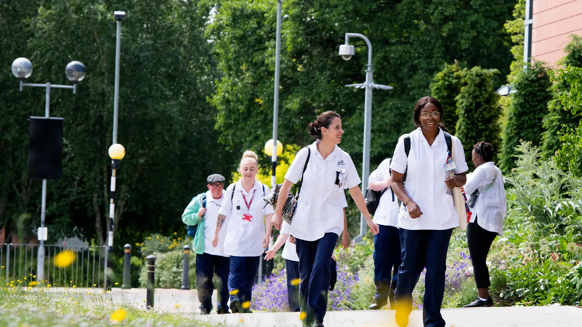 Nursing students in uniforms walking around Preston Campus and talking