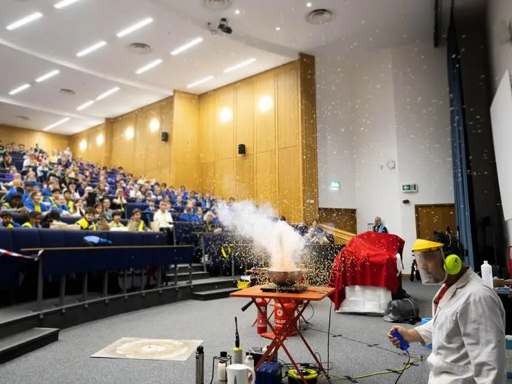 Primary school students watch a science show.