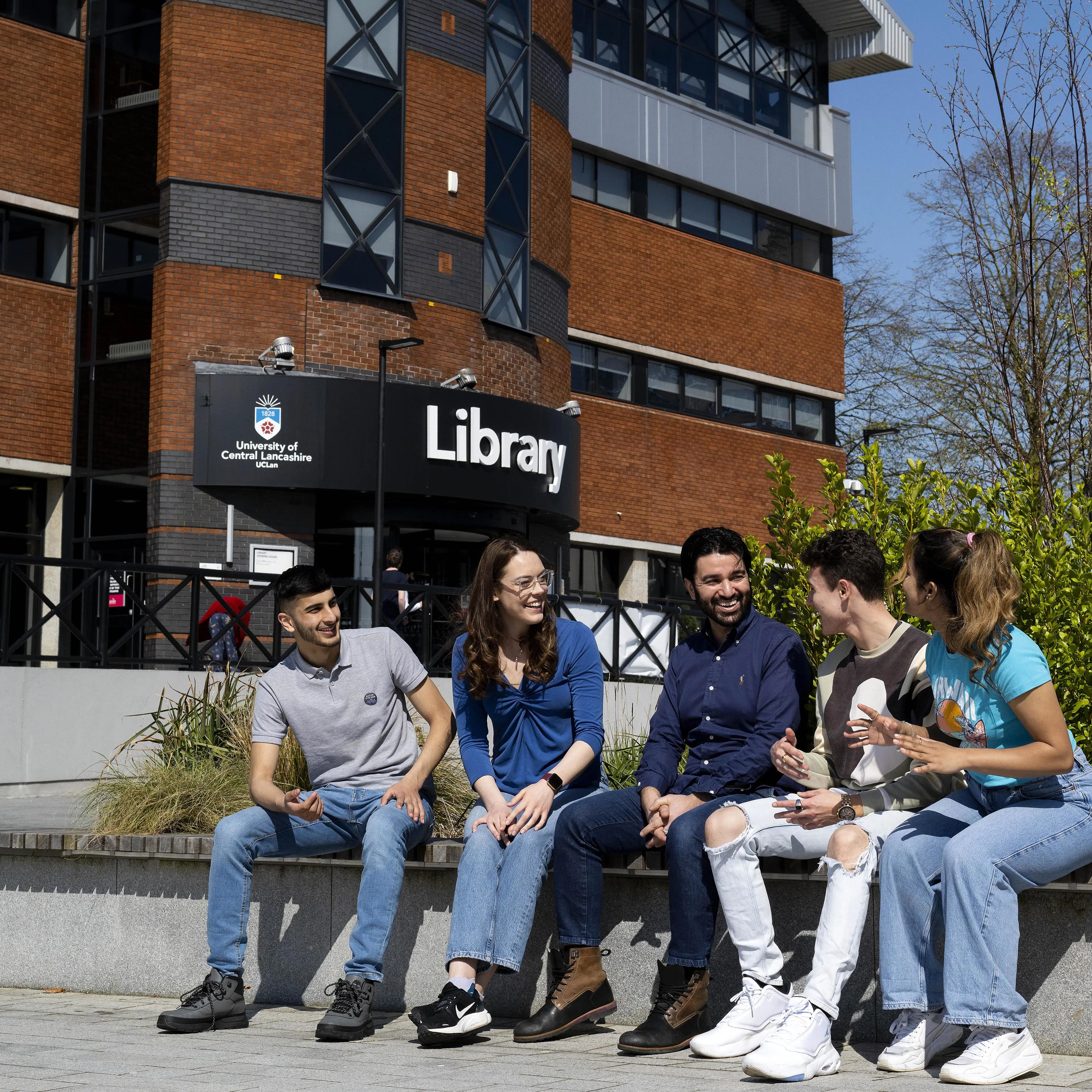 A group of students socialising outside Preston campus library