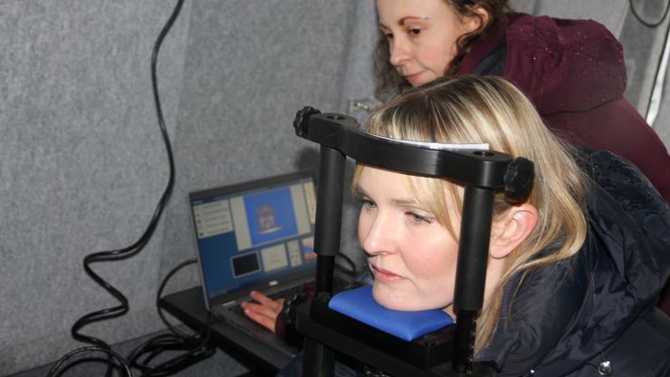 A colleague using eye movement tracking equipment in the mobile research unit van.