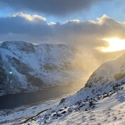 Snowy mountains during sunrise in the Lake District.