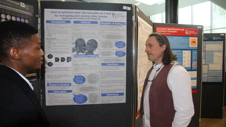A student discussing his work at the Research and Knowledge Exchange Festival.