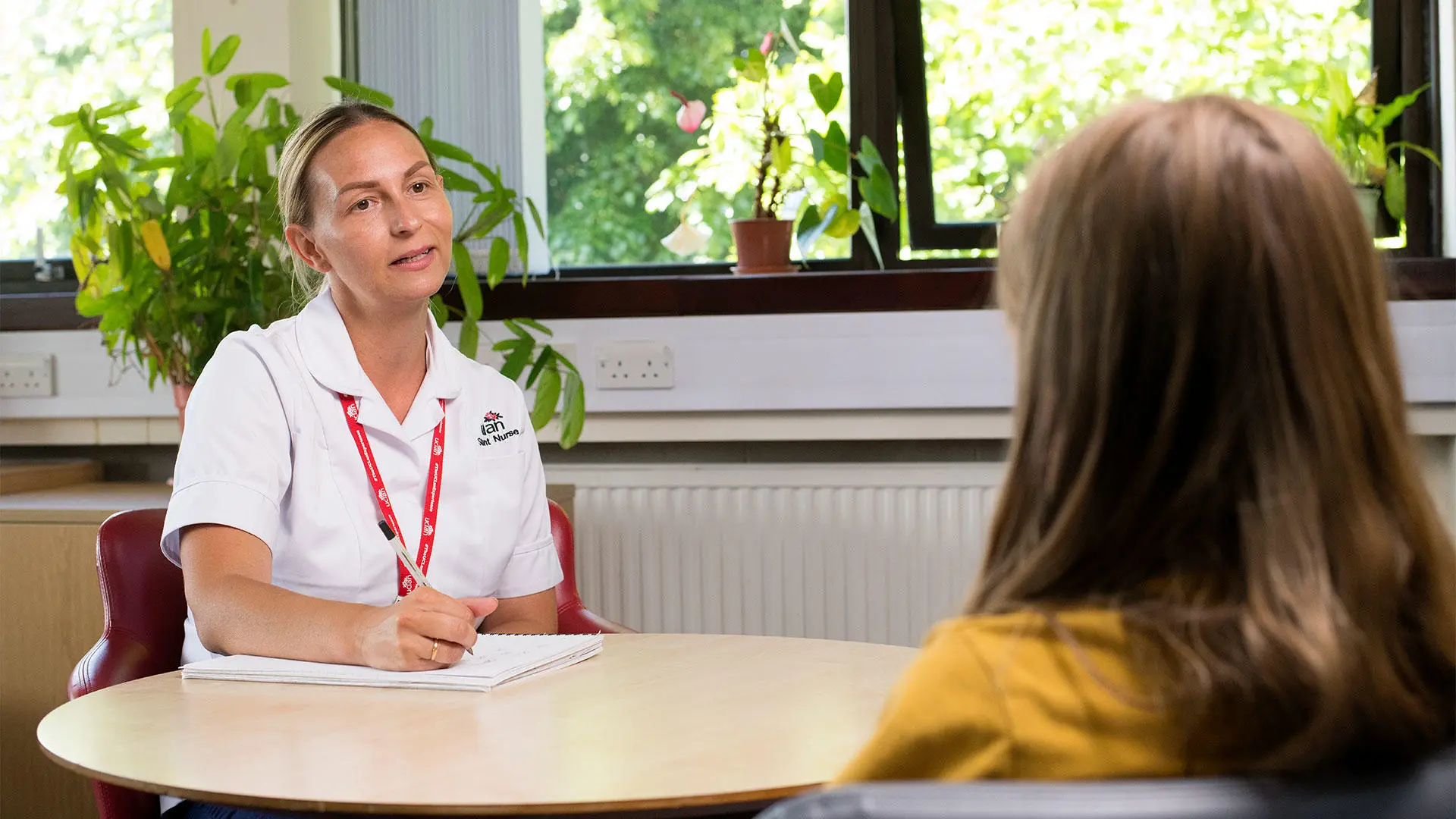 Student nurse talking to a patient
