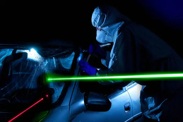 Forensic scientists work on a car