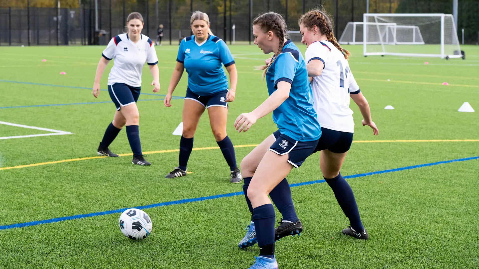 Students playing womens football match