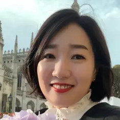 Mia Kim smiling outside with flowers in hand